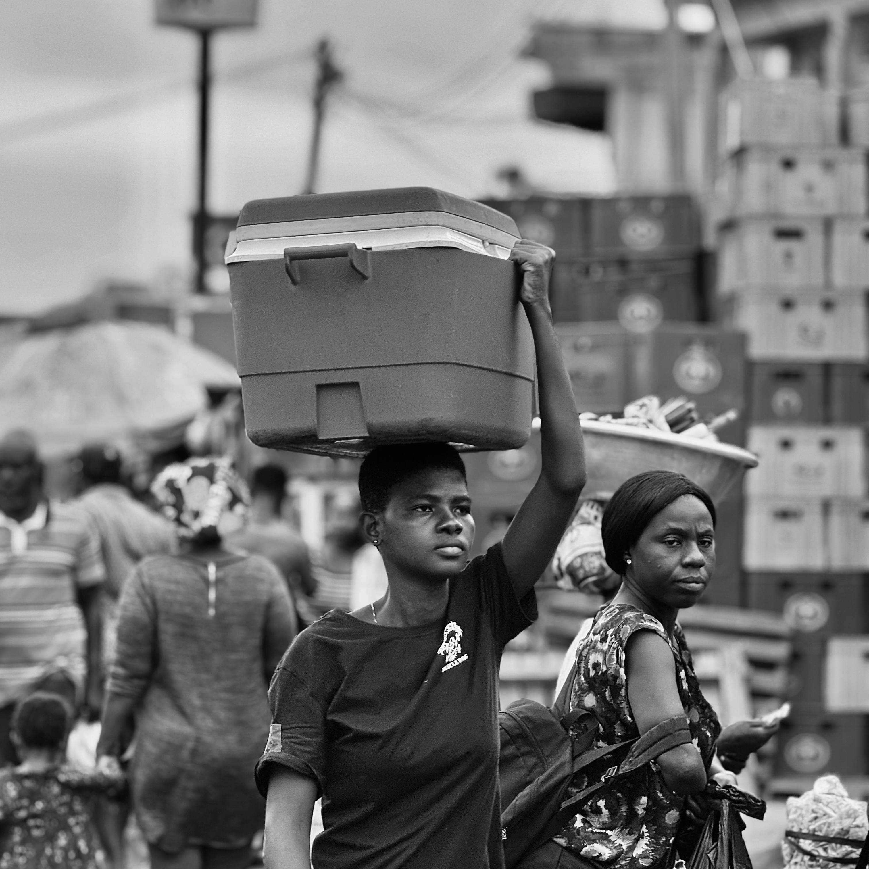 Nigerian market trader carrying goods